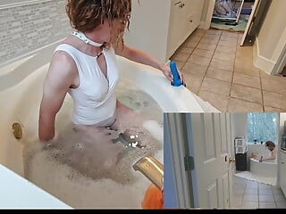 Playing with a dildo in the tub