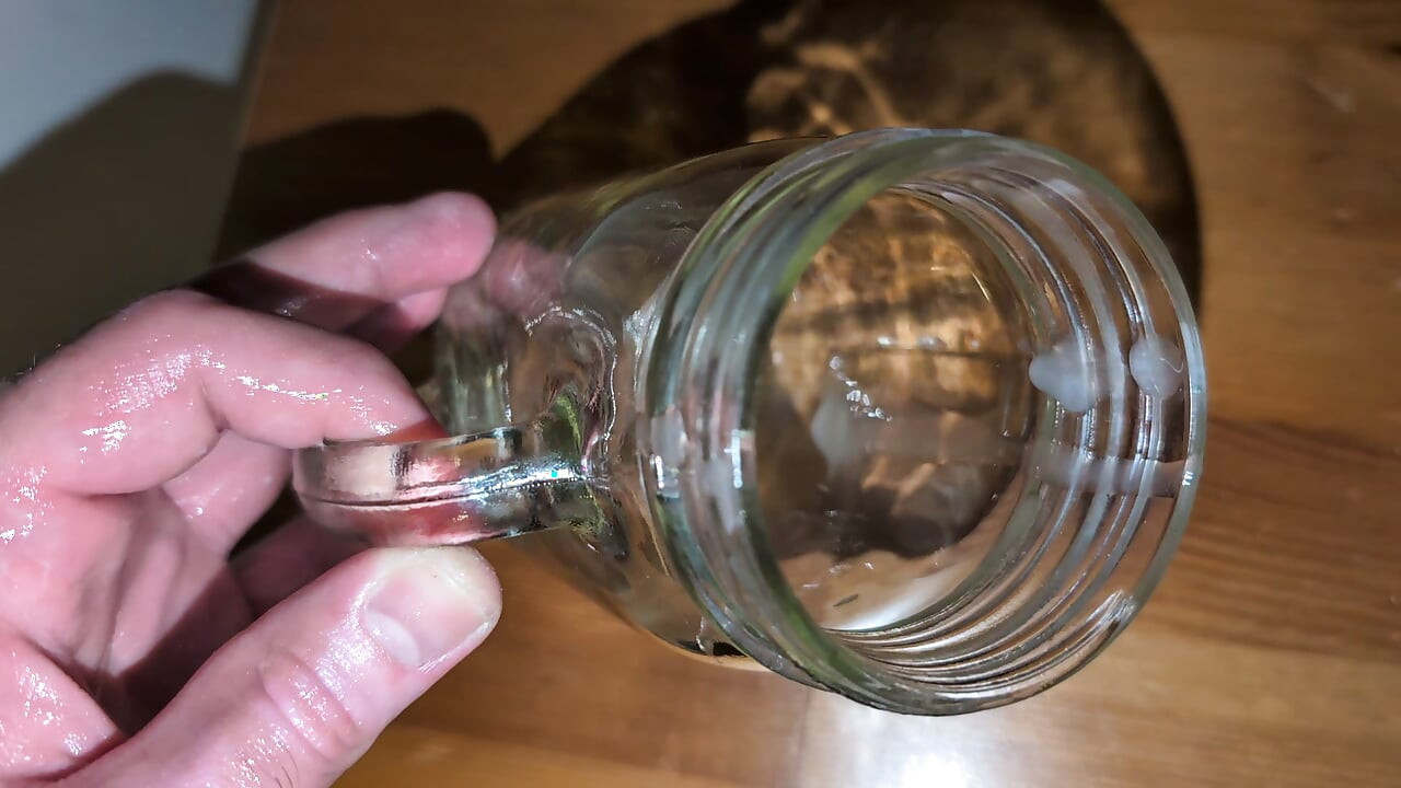 Fat man jerking his hard cock and cumming in a glass