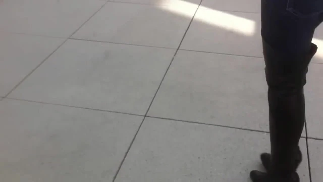 woman trying Thigh High Boots in public