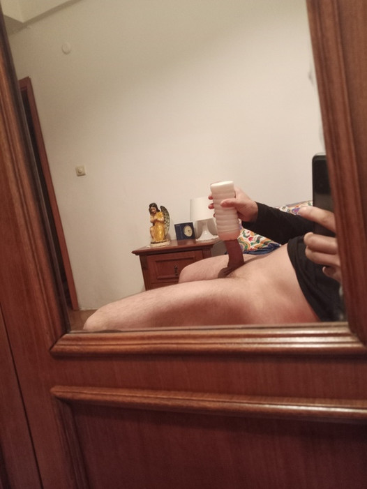 teen ejaculates in front of the mirror in bed with his toy