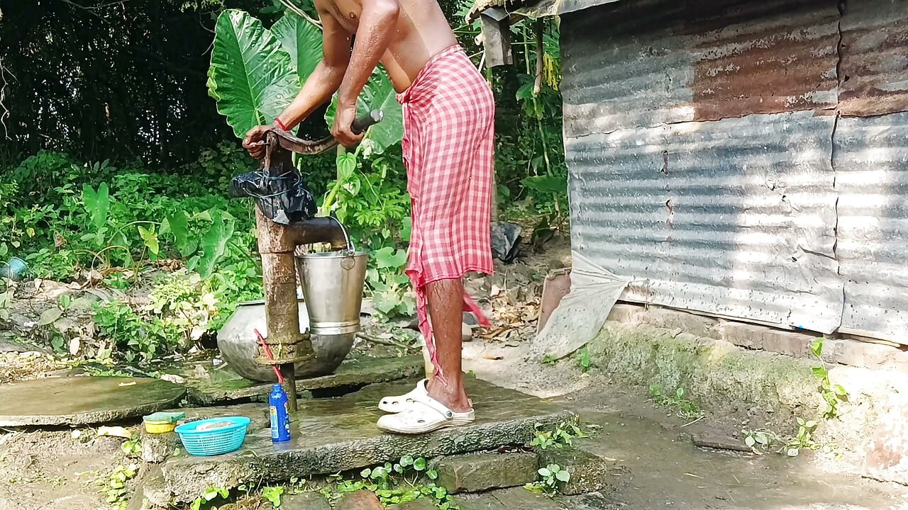 Desi young man bath Open place.