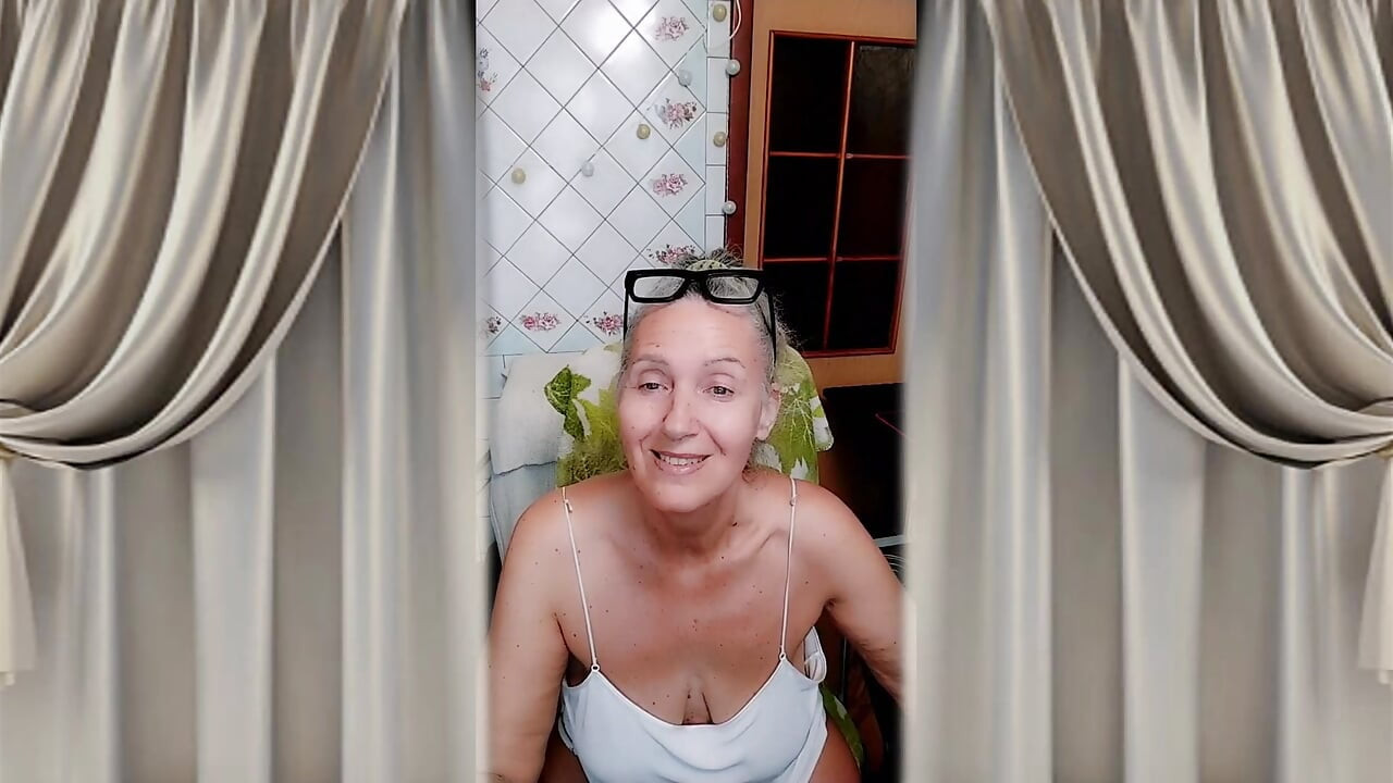 Hot housewife in the kitchen in home clothes.