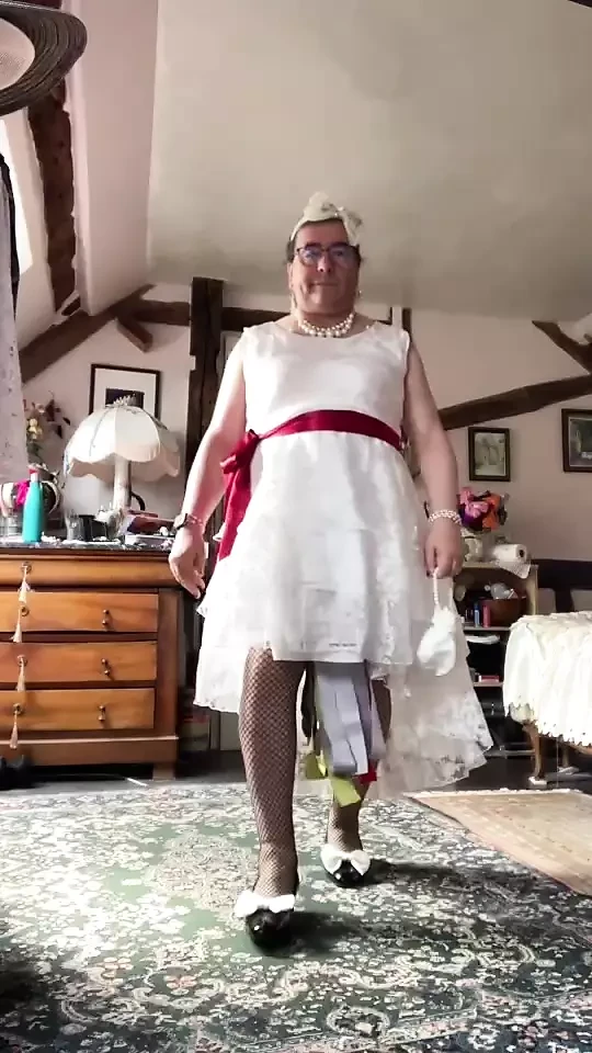 Uzun beyaz dantelli elbiseli bir kıyafet içinde bir akşam için gelinlik gibi stil.