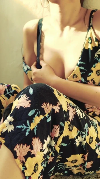 Pretty woman masturbates on camera in a dress and brings herself to a loud orgasm with her fingers.