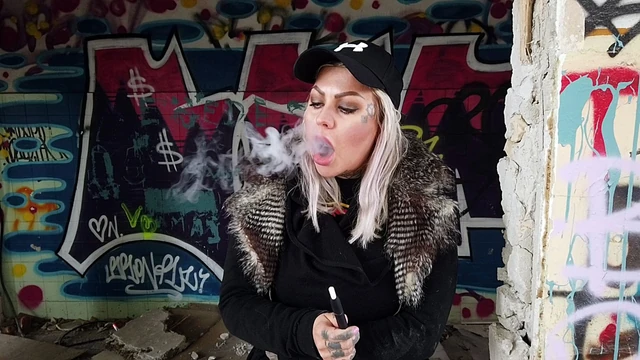Blonde Lady Smokes An Electric Cigarette On Stairs