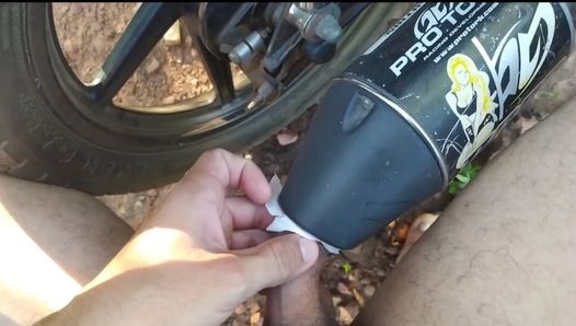 Boy fucks motorcycle with his little cock in the middle of the woods.