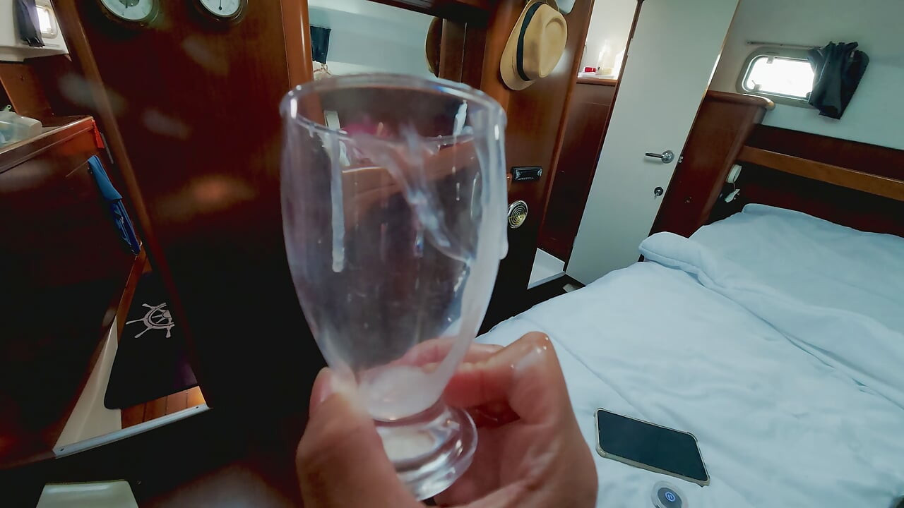 Trans masturbation while sailing and cum shot in the cup inside the boat