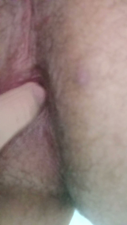 Scratching her ass with her fingertip