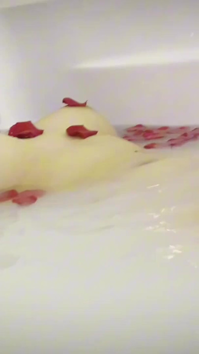 a milk shower with roses, and playing with her feet | Clip 1