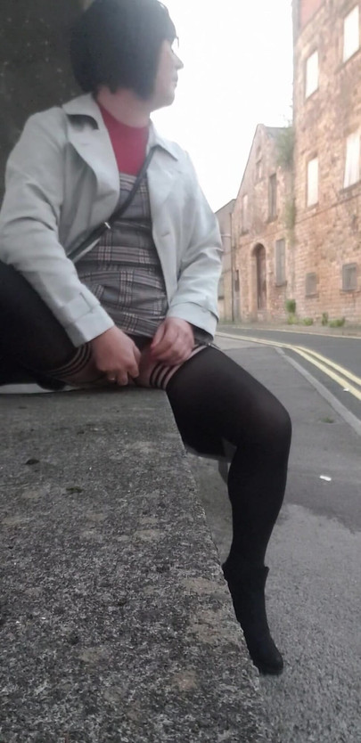 Stunning moment from "Crossdressing slut exposes her caged cock on public street"