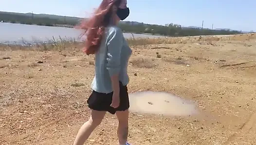 Girl undresses on a windy day