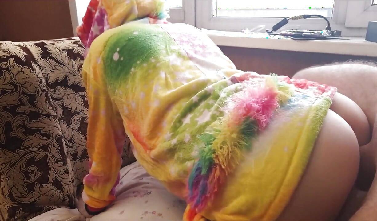 A baby in a unicorn costume shows off her ass