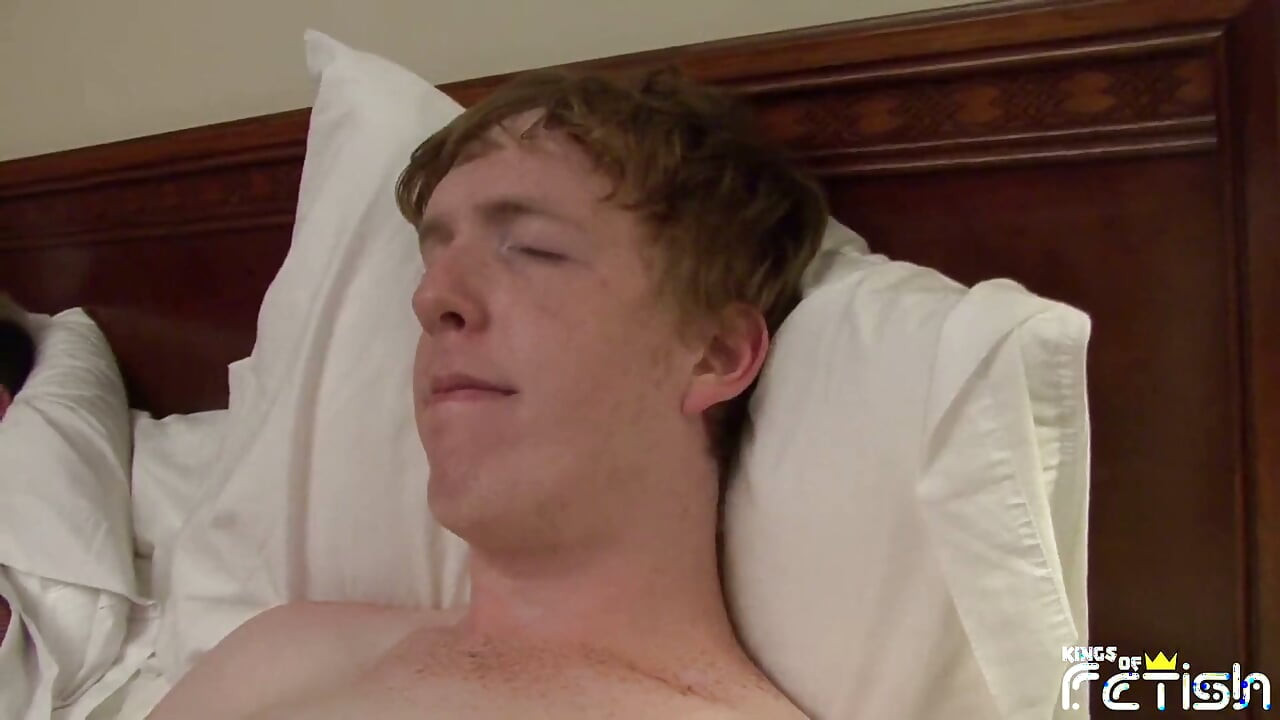 Young dude enjoys sucking two big cocks on the bed and licks cum