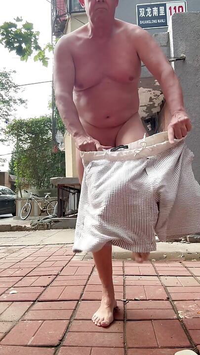 Naked dog pee in public