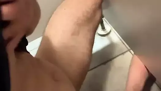 Twink jerks in public toilet stall and grabs random guy’s big dick and makes him cum