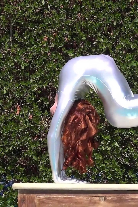 Bending in a Silver Spandex Suit