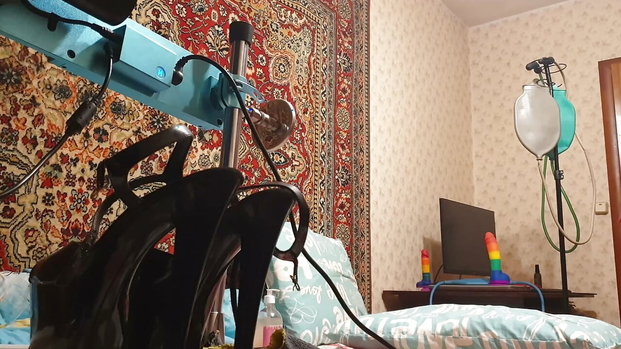 Sissy in fetish pvc dress having deep anal sex with a fuck machine
