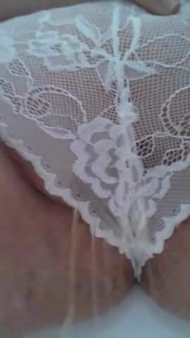 Pissing through her lacy panties