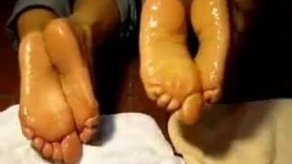 Two latinas with oily, wrinkled feet