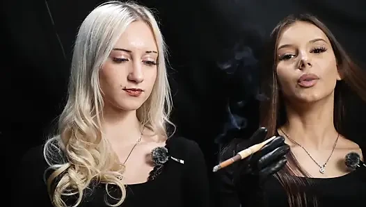 Two Women in Black Outfits Sharing a Cigarette with Slow Smoke and Playful Interaction
