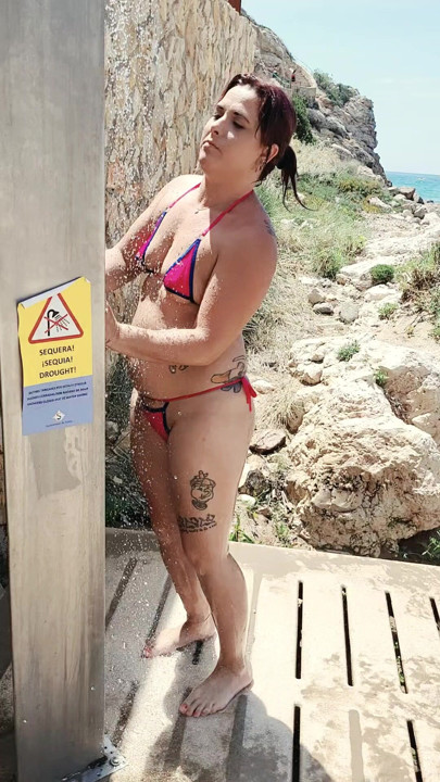 British wife showering on public beach