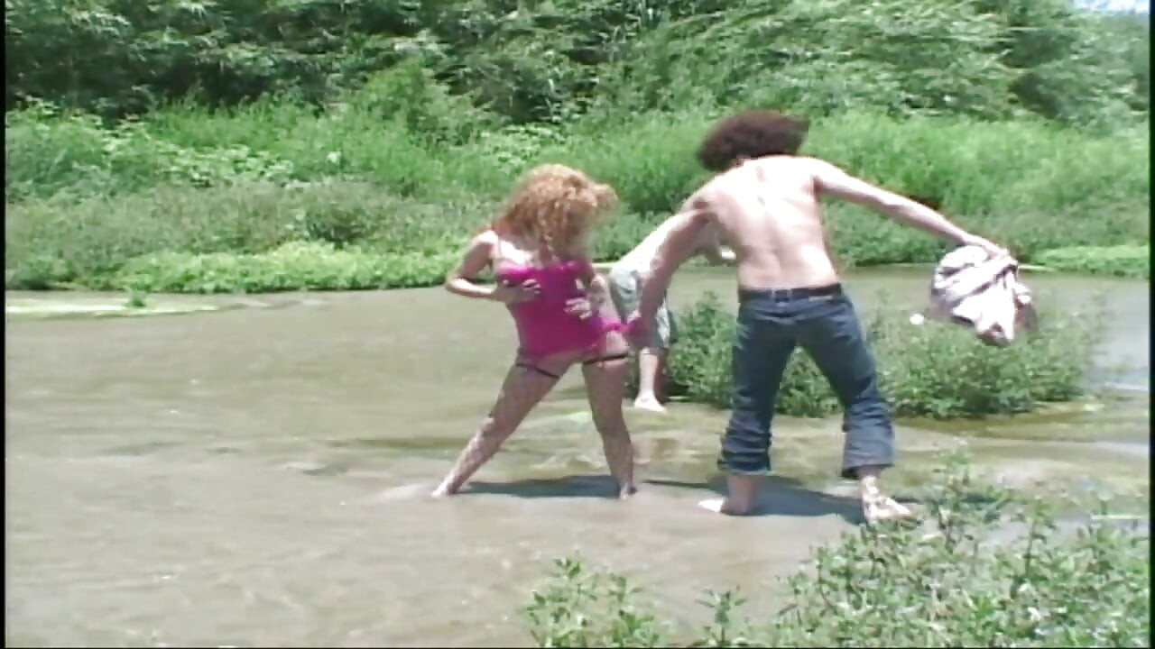 Redhead babe double penetrated in a lake