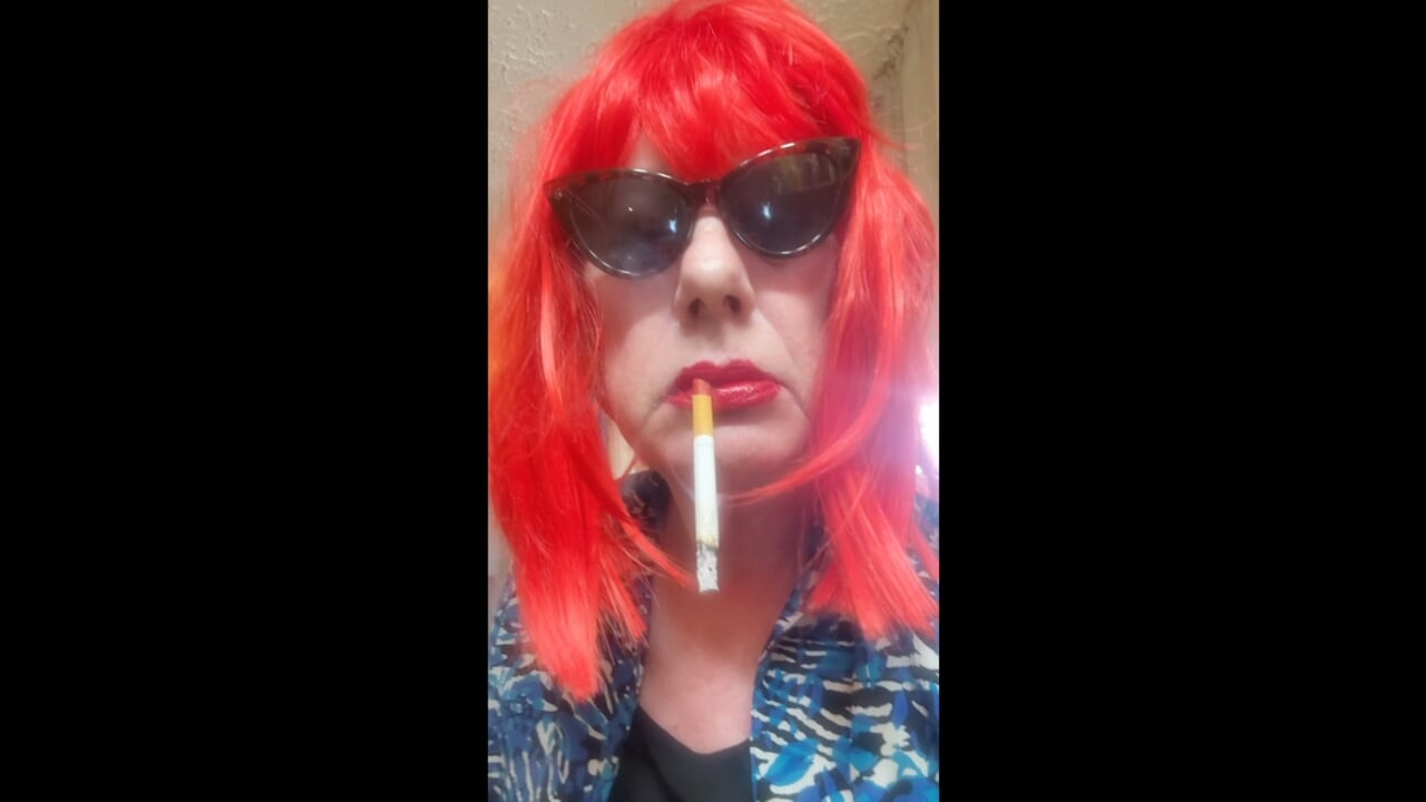 MRS. ROMAN DESTROYING A MARLBORO 100 MENTHOL CLOSE UP - WITH DANGLING AND NOSTRIL EXHALES