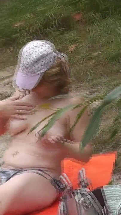 Memorable moment from "Wild beach. Random passerby guy peeps on sunbathing topless beautiful Milf on the river bank"