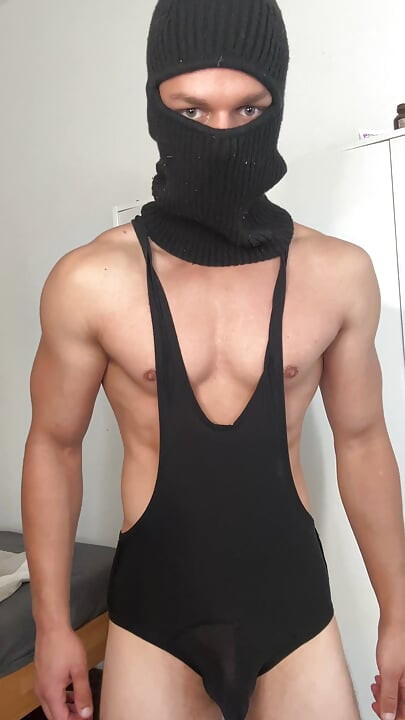 Muscle hunk teasing in a tight singlet