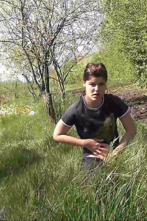 Pissing in grass on the side of the road