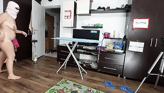 Sexy brunette doing naked chores around the house.