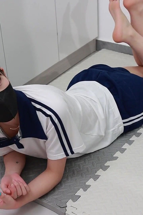 In a Couples' Game, the Girlfriend Must Pick up Coins Under the Constraints of Handcuffs and Shackles