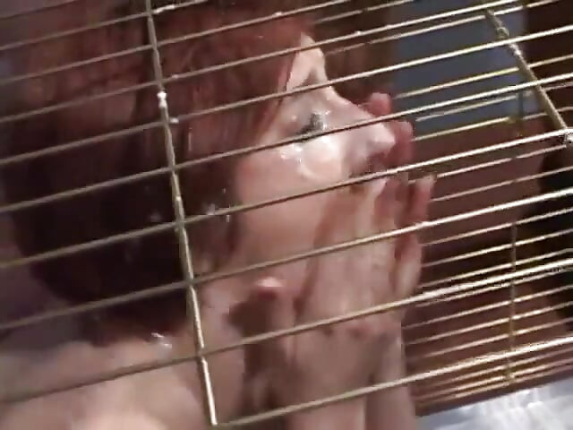 Submissive slut blowing police officers dick while in cage