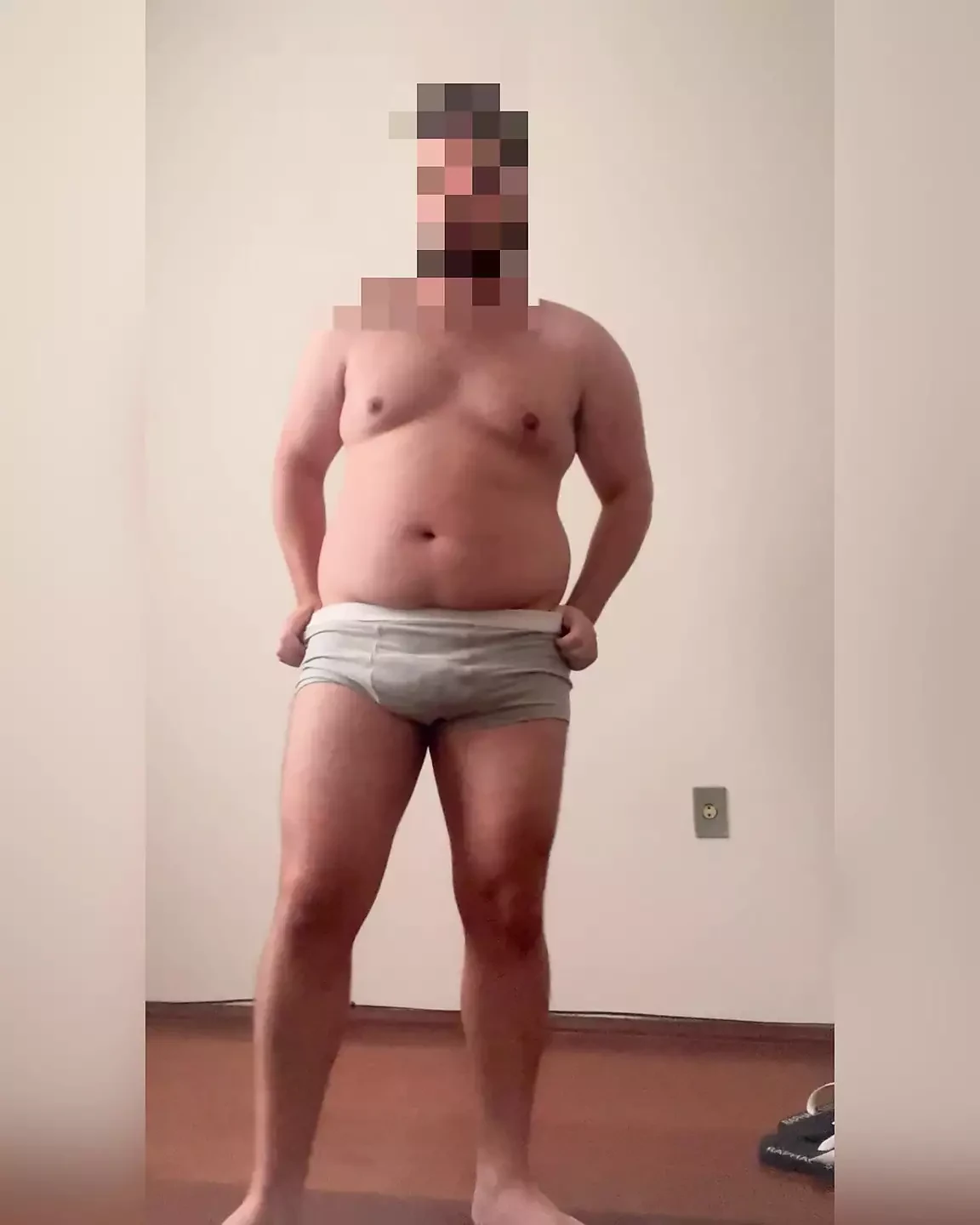 Chubby boy taking off clothes