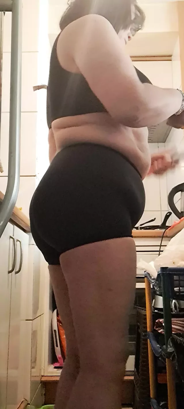stepmother in big panties in the kitchen, with hot movements