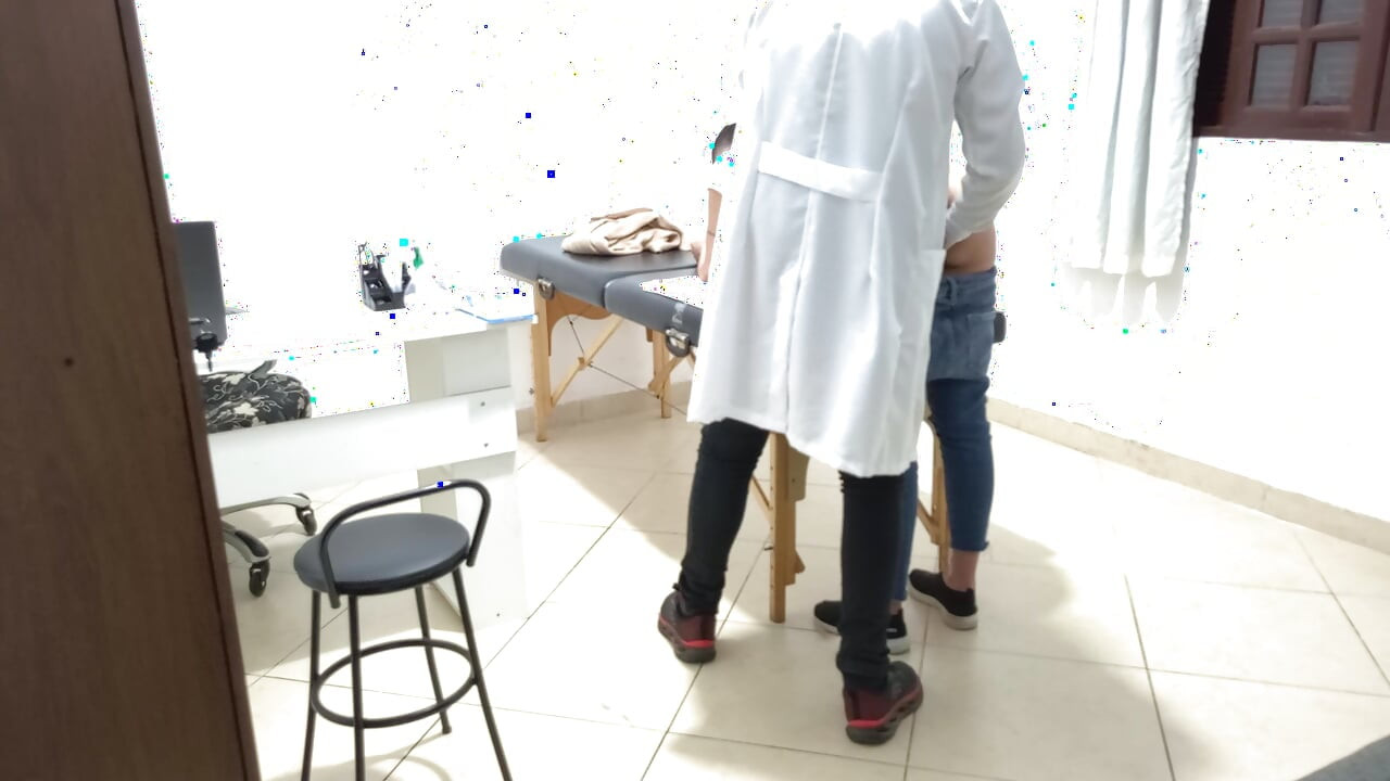 Proctologist performs anal exam on constipated patient.