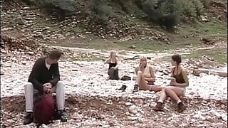 Beautiful brunette fucks a man by a creek