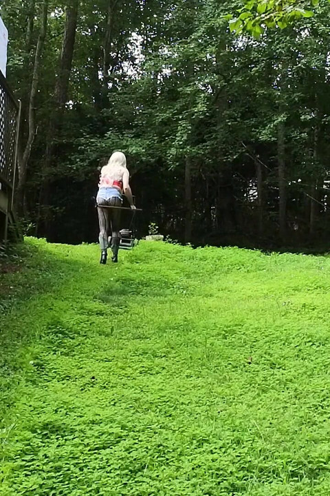 Big Fake Tits Crossdresser in Daisy Dukes Mowing Grass