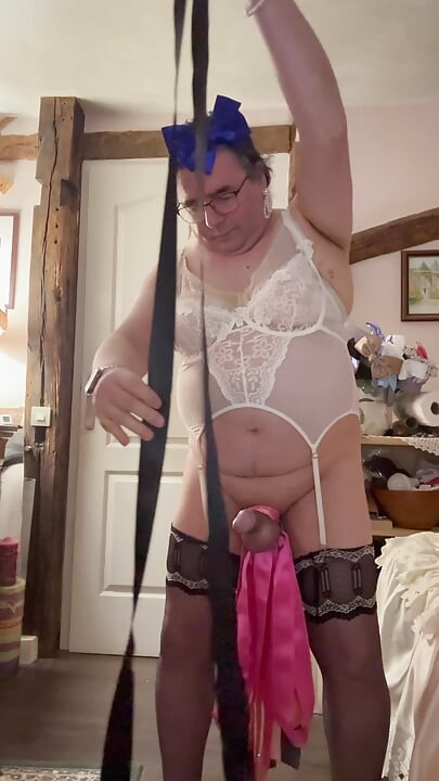 Dressed with lingerie to put ribbons around the clit and a chastity ribbon