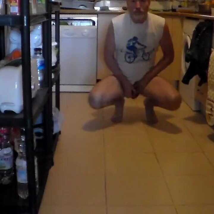 John is peeing on the kitchen floor
