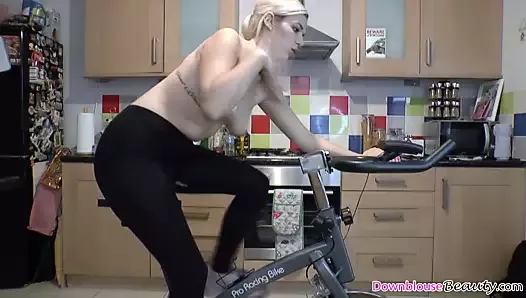 Blonde babe with yoga pants and topless rides fitness bike