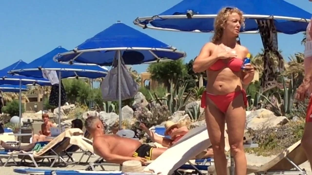 Nice Milf on the beach in orange bikini