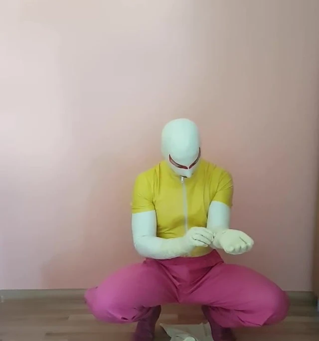 Rubberguy in colorful rubber clothes dresses more rubber