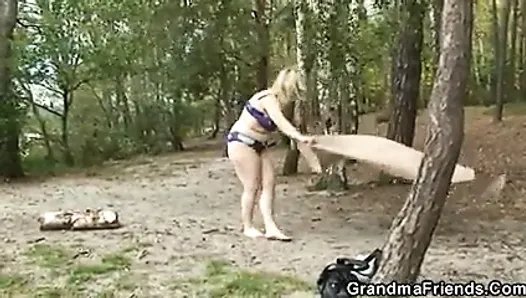 Flabby granny gets double dicked near the lake