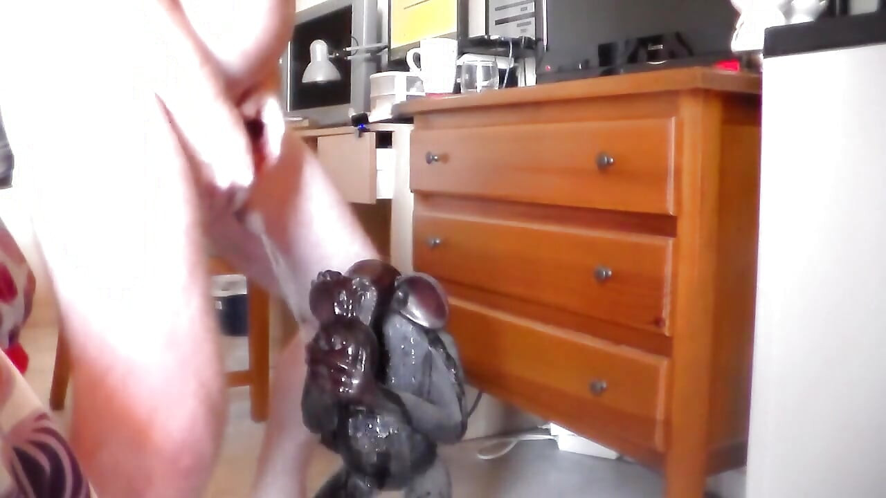 John is peeing on an ape statue