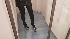 crossdresser in stripper high heels stockings and latex mini