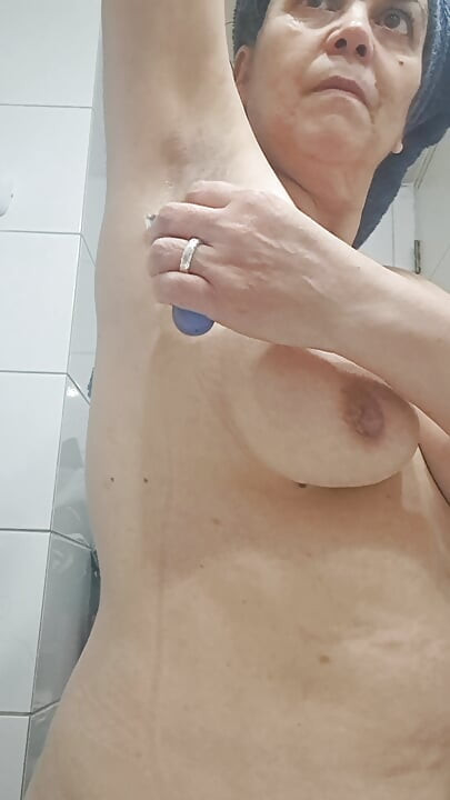 Mom shaves the few armpit hairs and some of the pubic hair on her hairy pussy