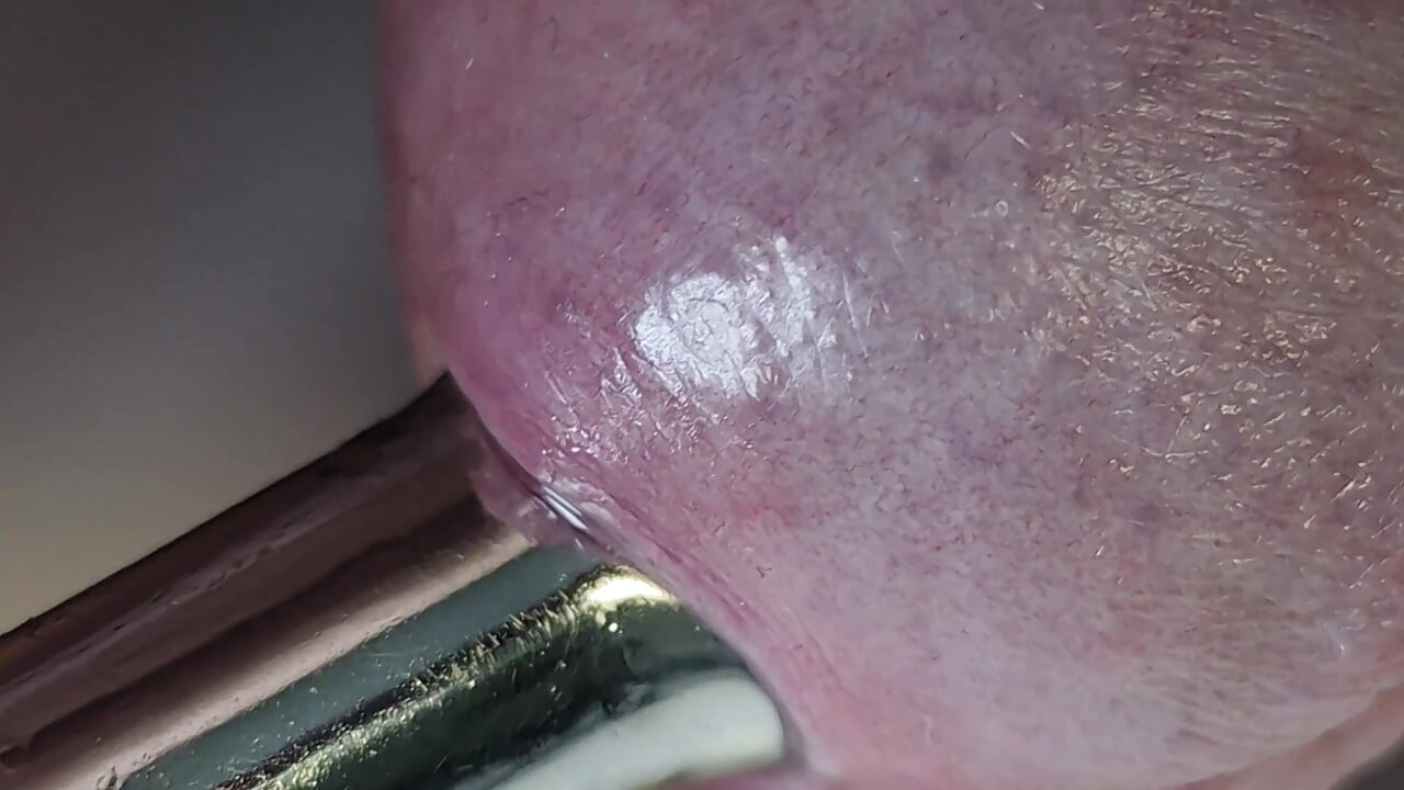 Pulling out extremely tight 14mm urethral teardrop plug close-up.
