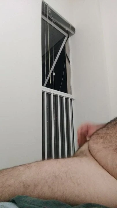 wank with cumshot in front of the apartment window