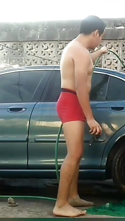 Jesus in red boxer washing his jaguar car